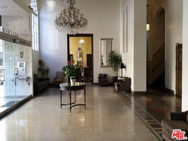 a living room with furniture and a chandelier