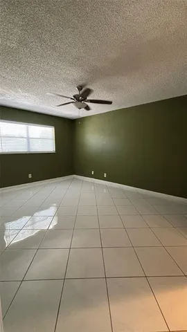 a view of a livingroom with an empty space and a kitchen space
