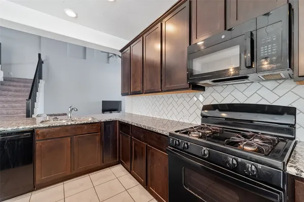 a kitchen with stainless steel appliances a sink stove and microwave