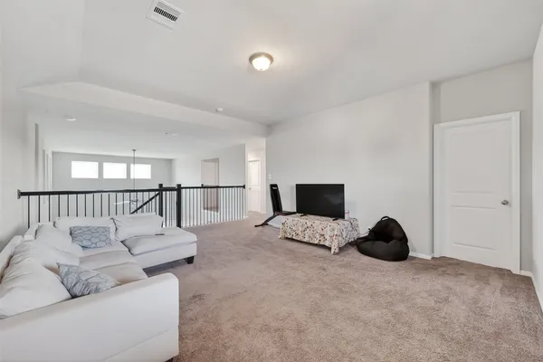 a large bedroom with a bed and a window