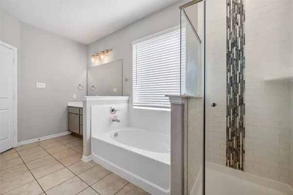 a bathroom with a bathtub and a shower