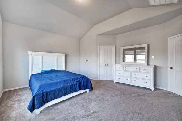 a bedroom with a bed and a dresser