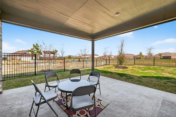 a view of a chairs and table in the patio