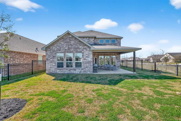 a view of a house with a yard and porch