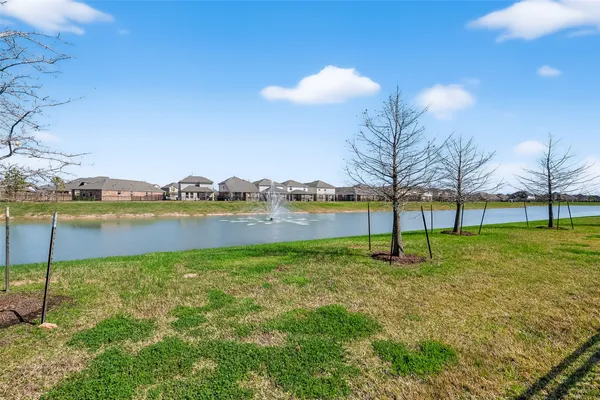 a view of a lake with houses in the background