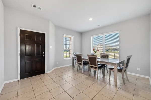 a view of a dining room with furniture and window