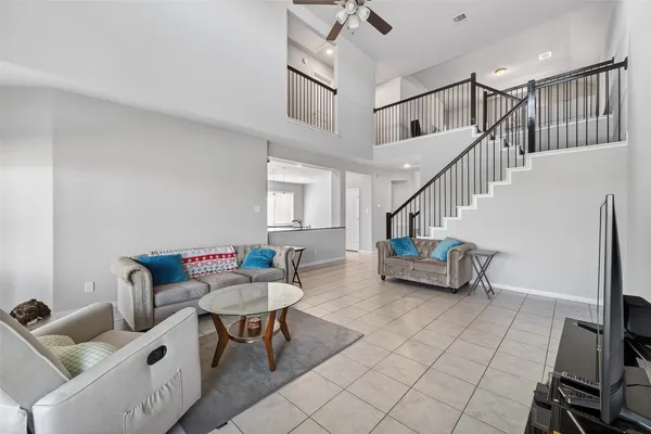 a living room with furniture and a dining table