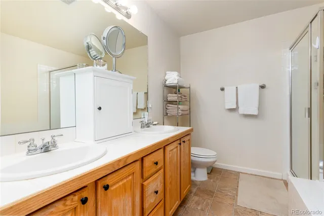 a white bath tub sitting next to a white sink and vanity