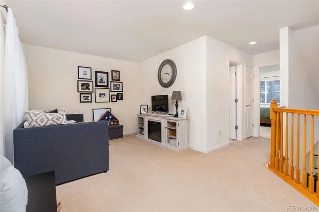 a bedroom with a bed and a chair next to a window