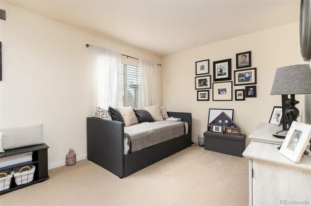 a bedroom with a bed and a painting on the wall