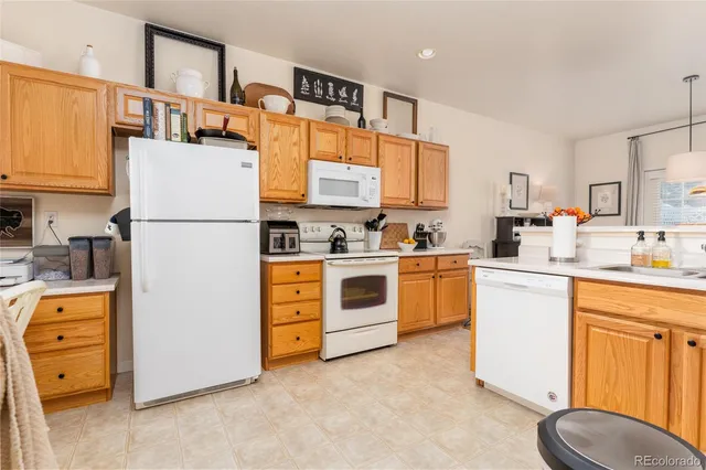 a kitchen with stainless steel appliances kitchen island granite countertop a sink a stove and a refrigerator