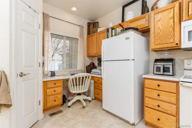 a dining room with furniture a chandelier and wooden floor