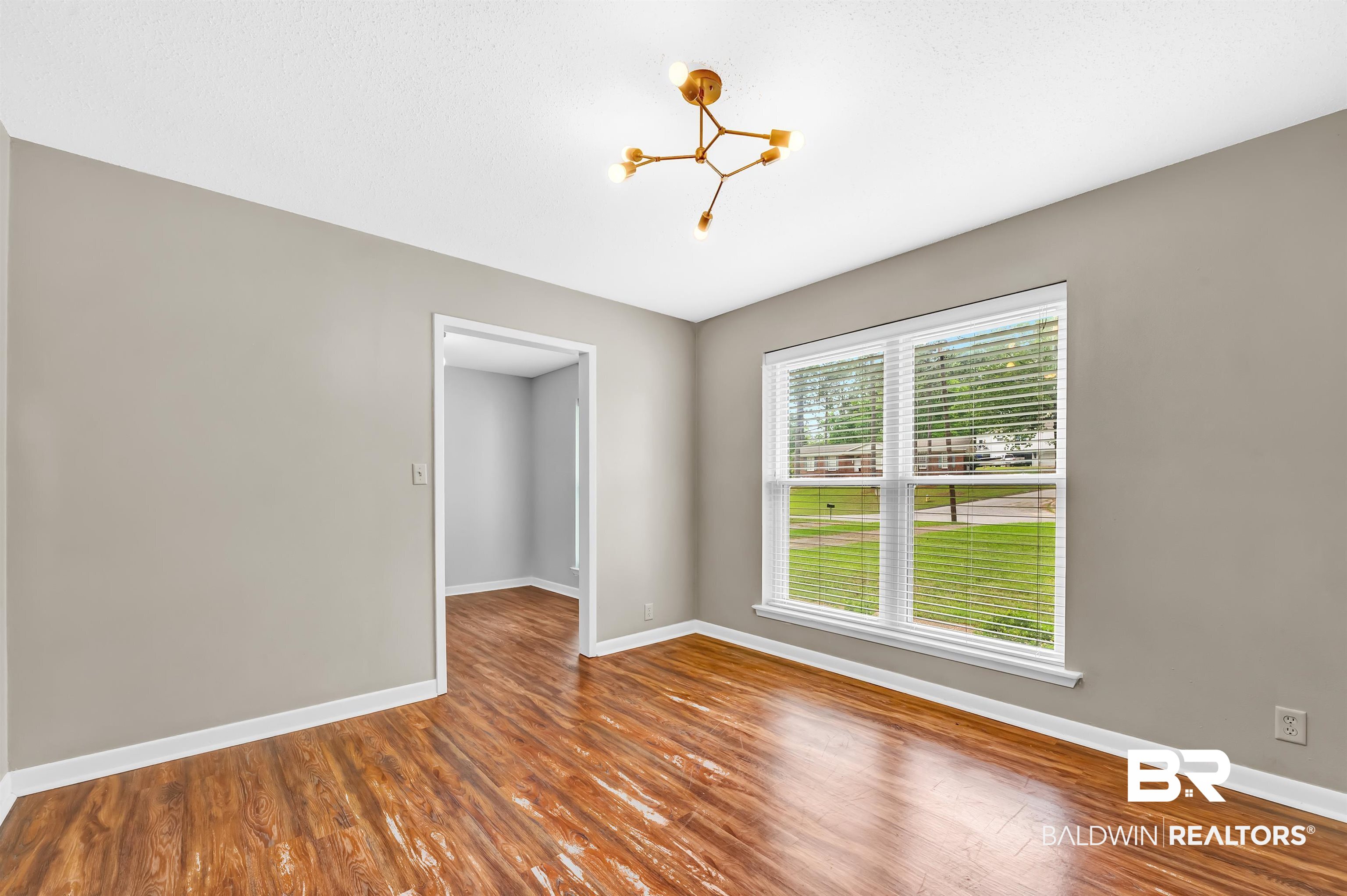 28 Caisson Trace Spanish Fort, AL 36527 - Photo 7 of 51 Formal living featuring a notable chandelier, wood finished floors, and baseboards