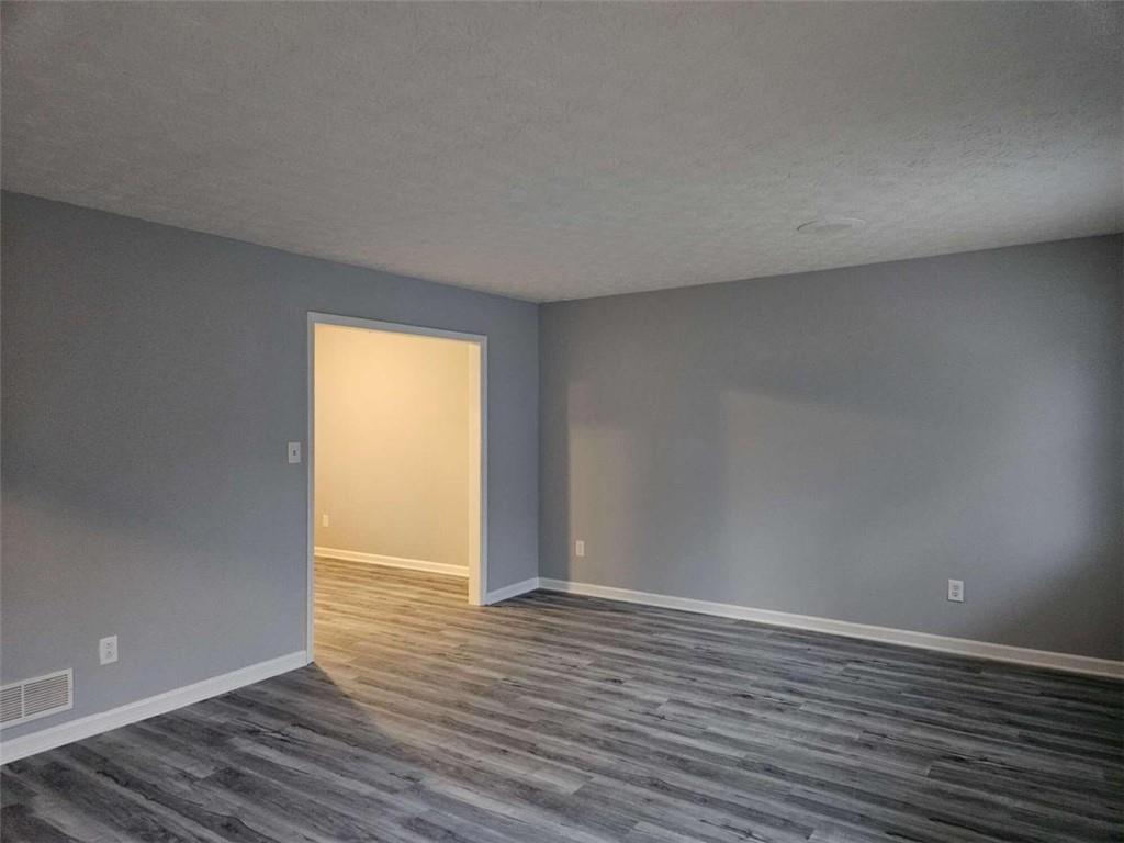 4321 Sebring Walk Decatur, GA 30034 - Photo 13 of 31 a view of an empty room with wooden floor and a window