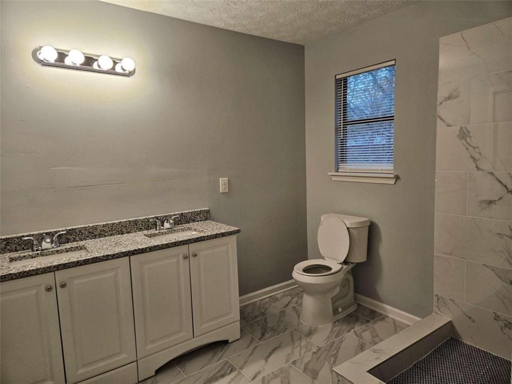 4321 Sebring Walk Decatur, GA 30034 - Photo 21 of 31 a bathroom with a granite countertop toilet and a sink
