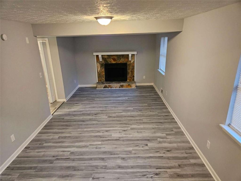 4321 Sebring Walk Decatur, GA 30034 - Photo 23 of 31 a view of a hallway with wooden floor and a fireplace