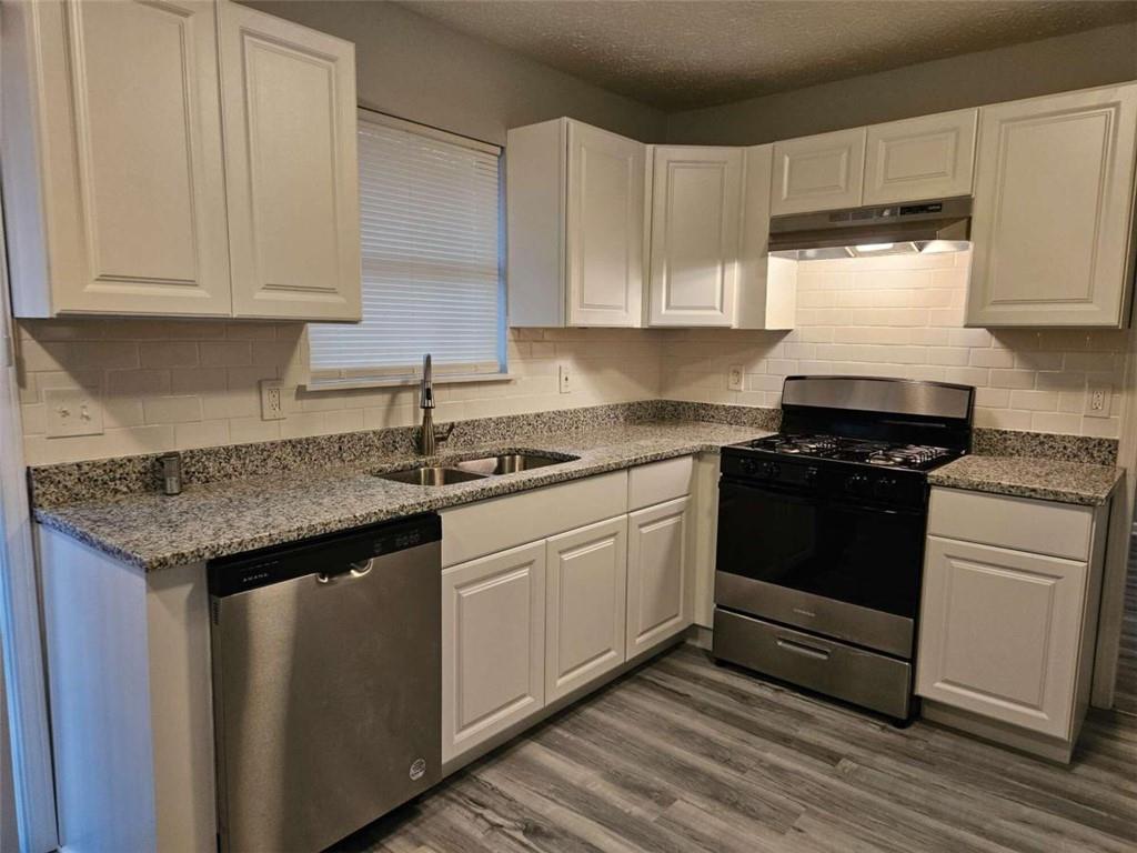 4321 Sebring Walk Decatur, GA 30034 - Photo 6 of 31 a kitchen with granite countertop white cabinets and a stove