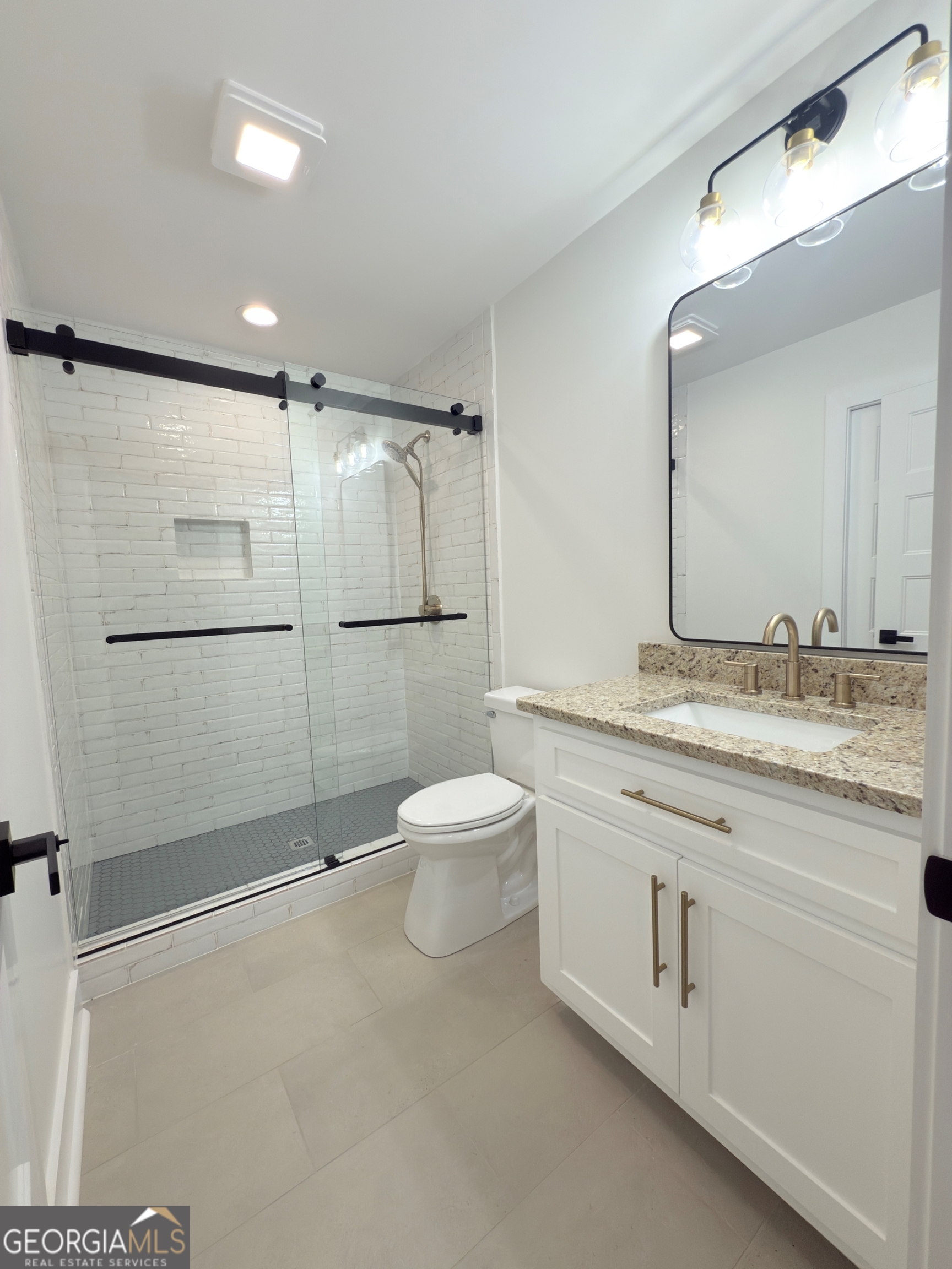 227 Morgan Farm Road Leesburg, GA 31763 - Photo 28 of 33 a bathroom with a granite countertop shower sink vanity and toilet