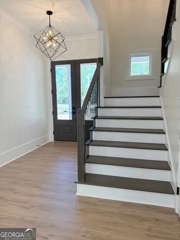 a large kitchen with stainless steel appliances kitchen island granite countertop a large counter top and wooden floors