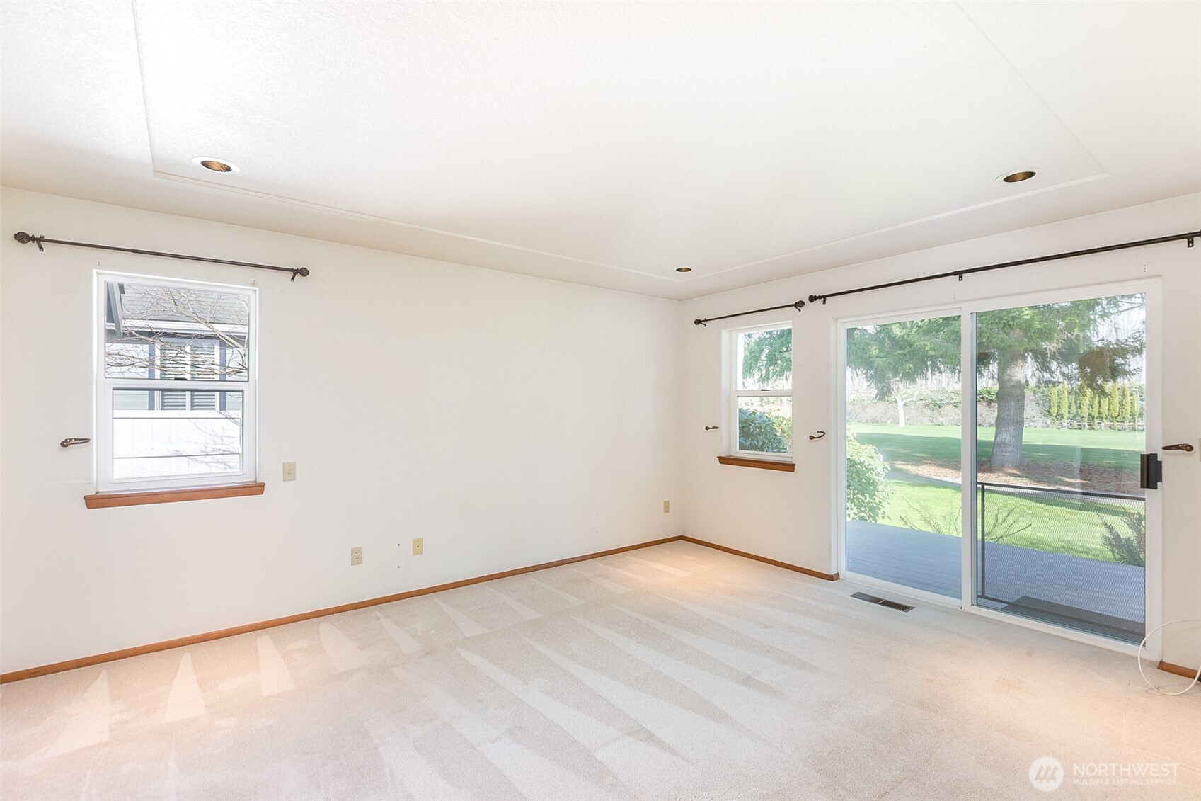 170 Hurricane Ridge Drive Sequim, WA 98382 - Photo 23 of 39 an empty room with wooden floor and windows