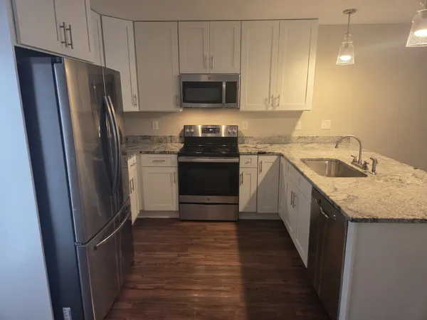 a kitchen with a refrigerator stove and sink
