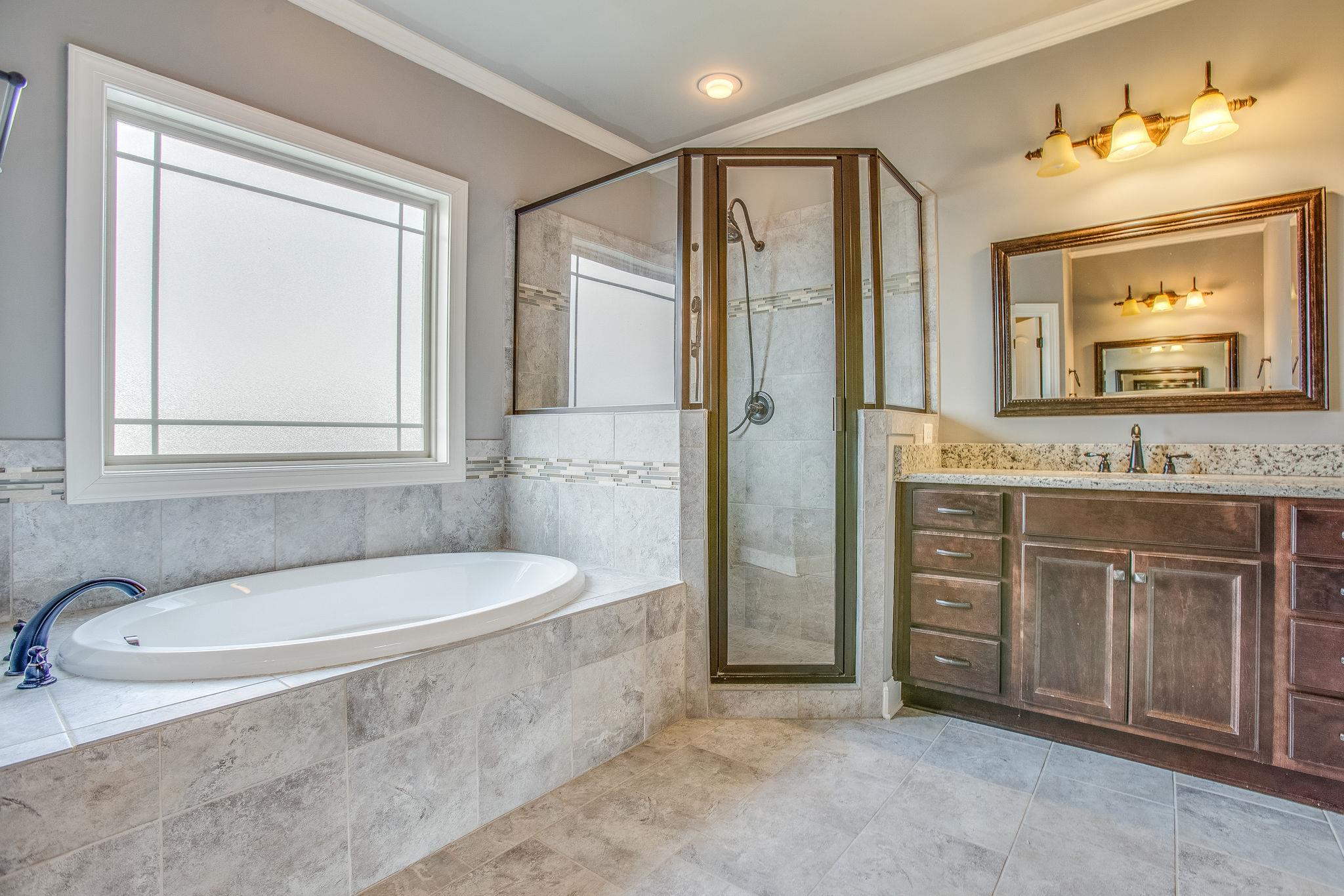 7026 Brindle Ridge Way Spring Hill, TN 37174 - Photo 12 of 23 Master bath large soaking tub and tile surround shower.