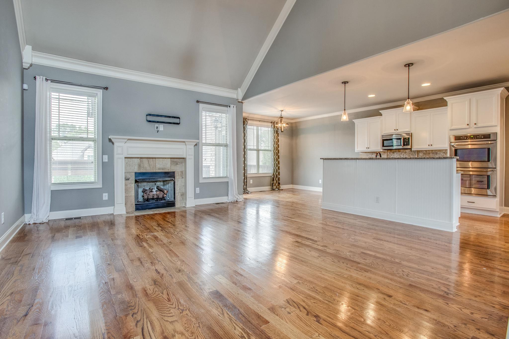 7026 Brindle Ridge Way Spring Hill, TN 37174 - Photo 4 of 23 Large living room with vaulted ceiling and gas fireplace.