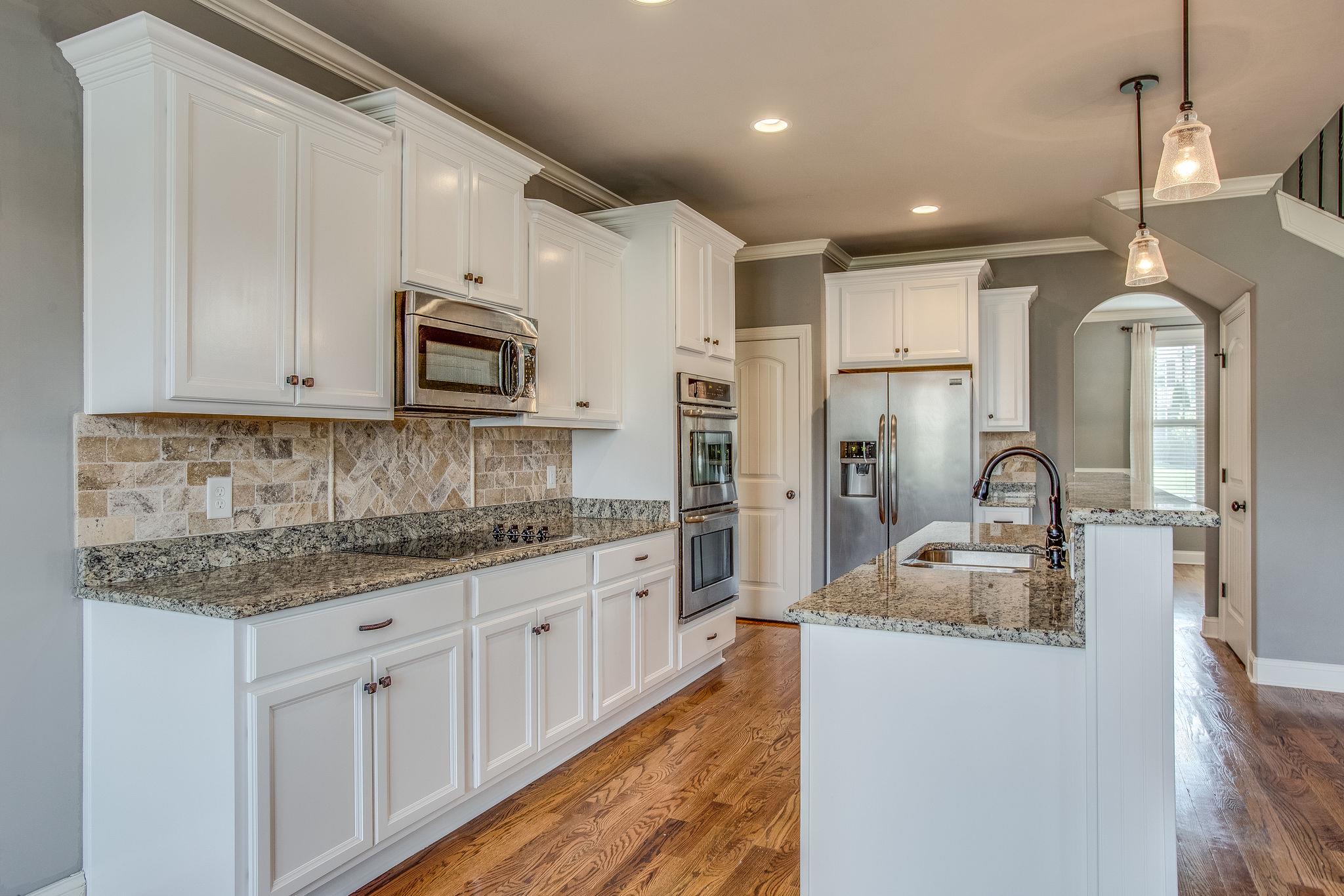 7026 Brindle Ridge Way Spring Hill, TN 37174 - Photo 6 of 23 White custom cabinets, granite counters, stainless appliances.