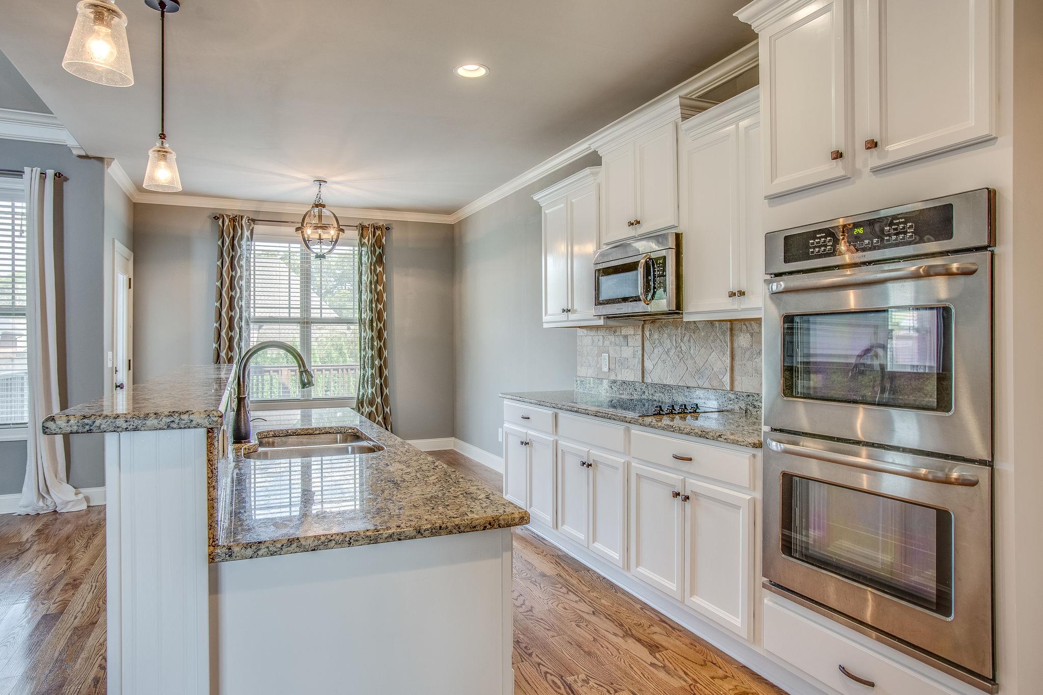 7026 Brindle Ridge Way Spring Hill, TN 37174 - Photo 7 of 23 Double ovens in the kitchen with view of the breakfast area.