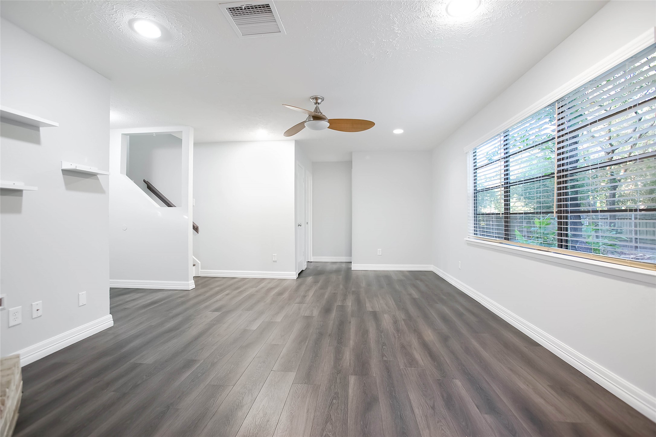 56 East White Willow Circle Spring, TX 77381 - Photo 11 of 45 wooden floor in an empty room with a window