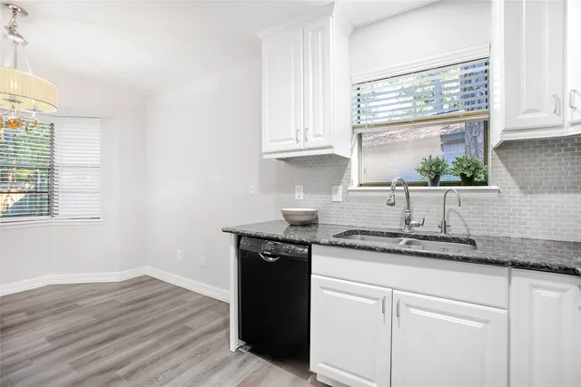 a kitchen with a sink and cabinets