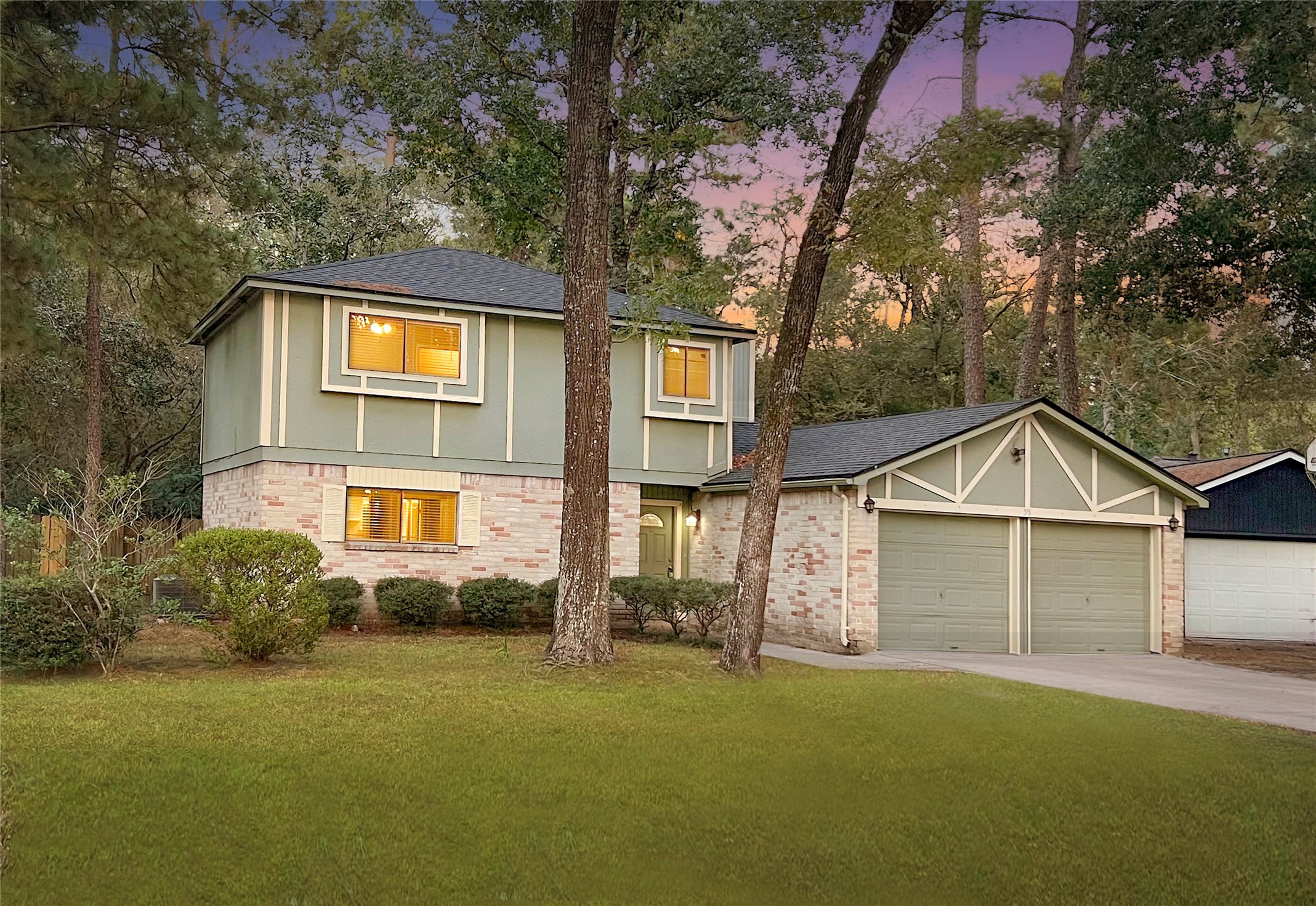 56 East White Willow Circle Spring, TX 77381 - Photo 2 of 45 a view of a yard in front of a house with large trees