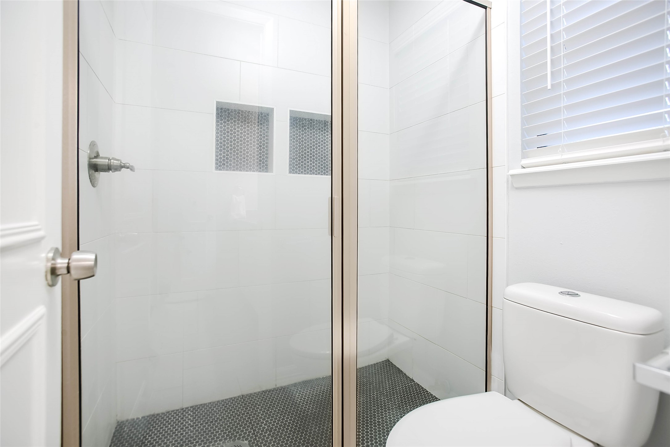 56 East White Willow Circle Spring, TX 77381 - Photo 22 of 45 a white toilet sitting next to a bathroom sink