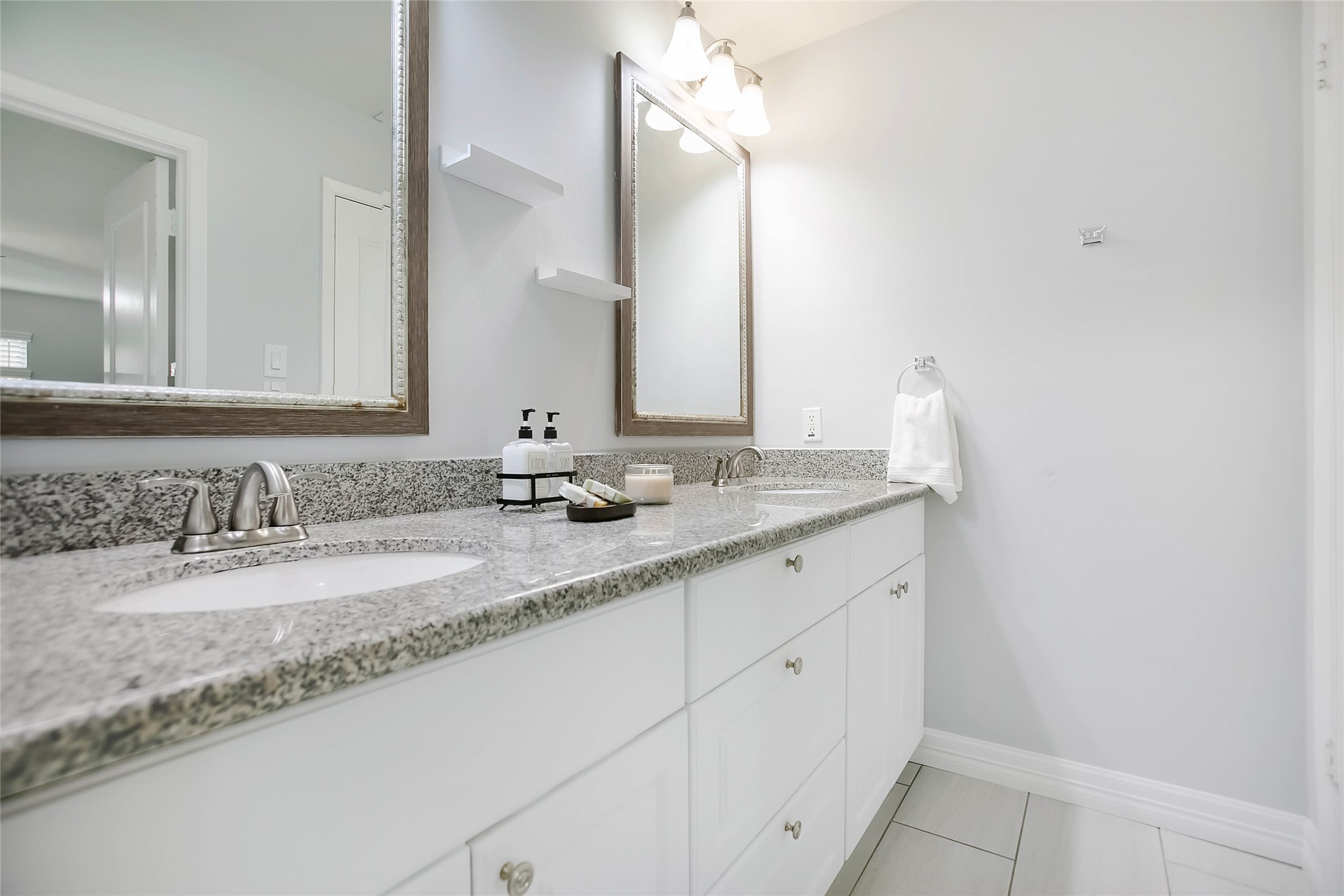 56 East White Willow Circle Spring, TX 77381 - Photo 23 of 45 a bathroom with a granite countertop sink and a mirror