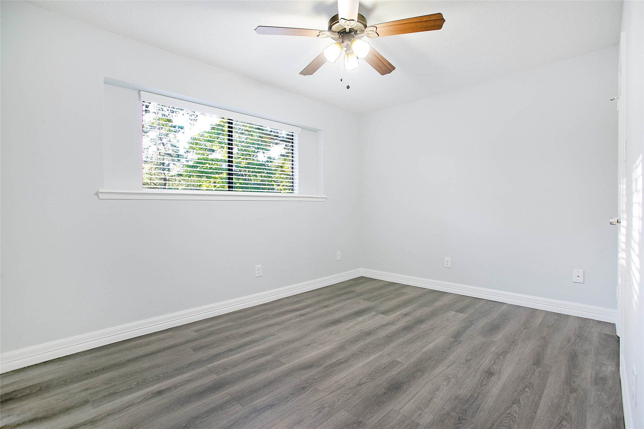 56 East White Willow Circle Spring, TX 77381 - Photo 26 of 45 wooden floor in an empty room with a window