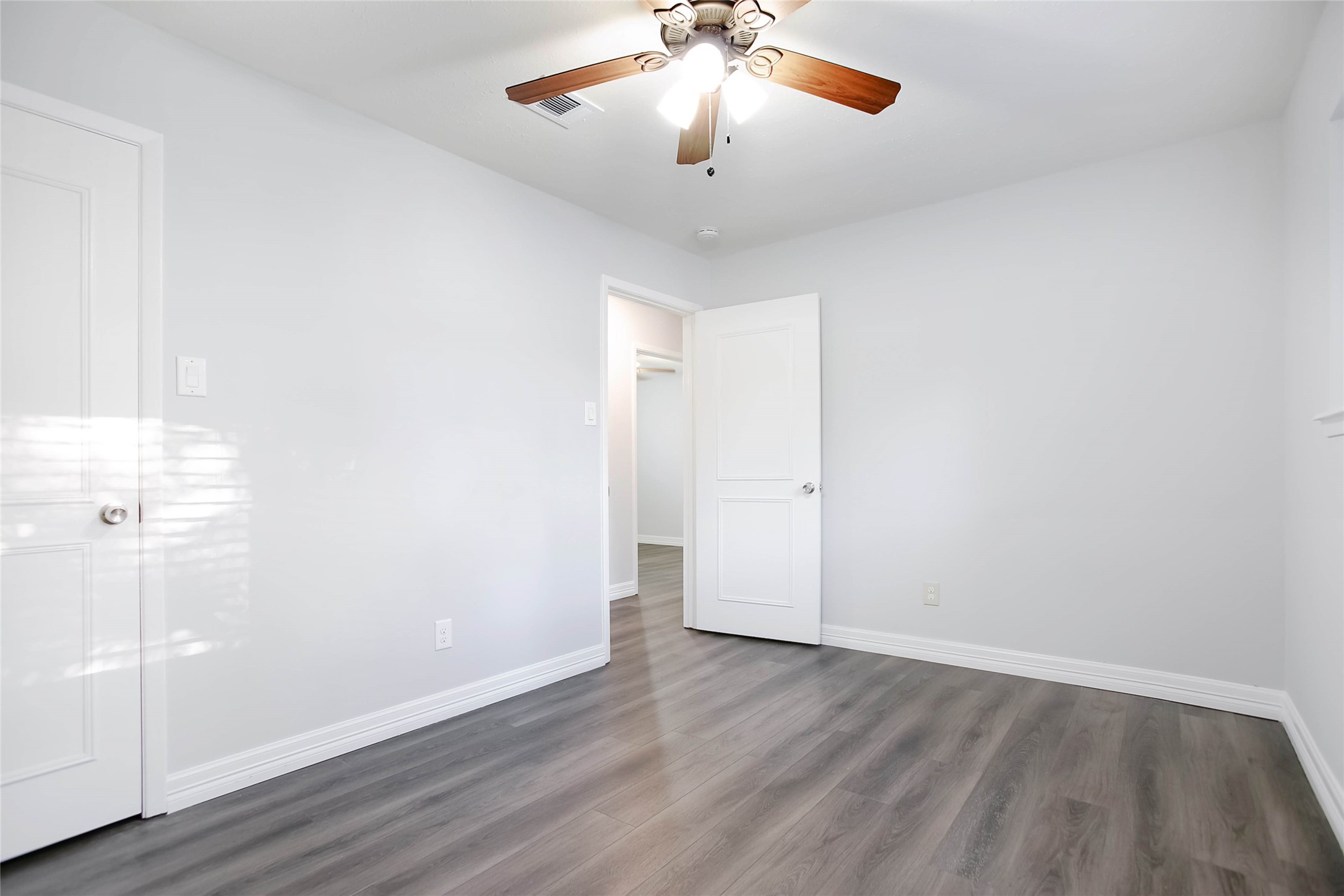 56 East White Willow Circle Spring, TX 77381 - Photo 27 of 45 an empty room with wooden floor and windows
