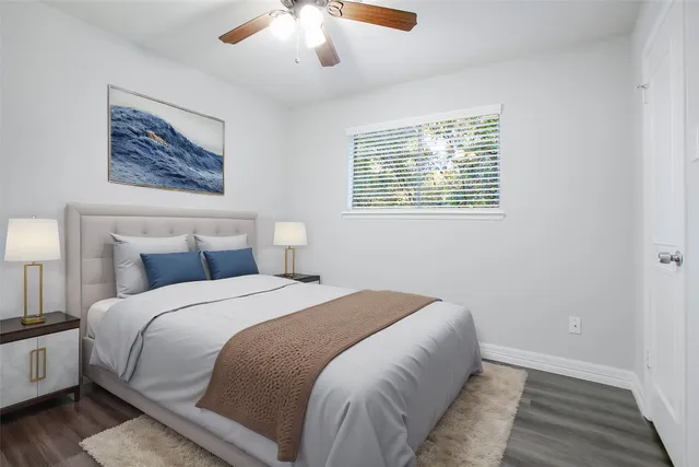 a bedroom with a large bed and a chandelier