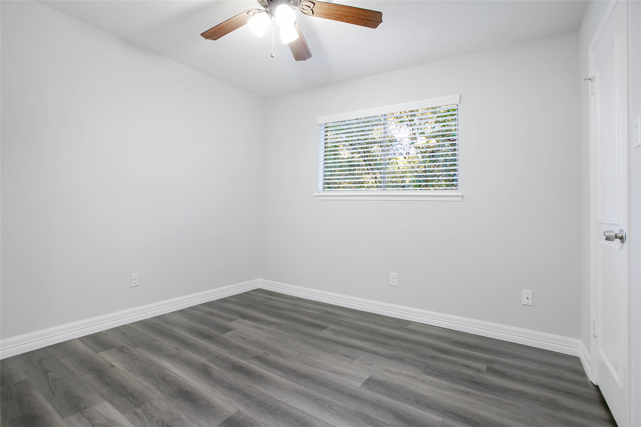 56 East White Willow Circle Spring, TX 77381 - Photo 29 of 45 an empty room with wooden floor and windows