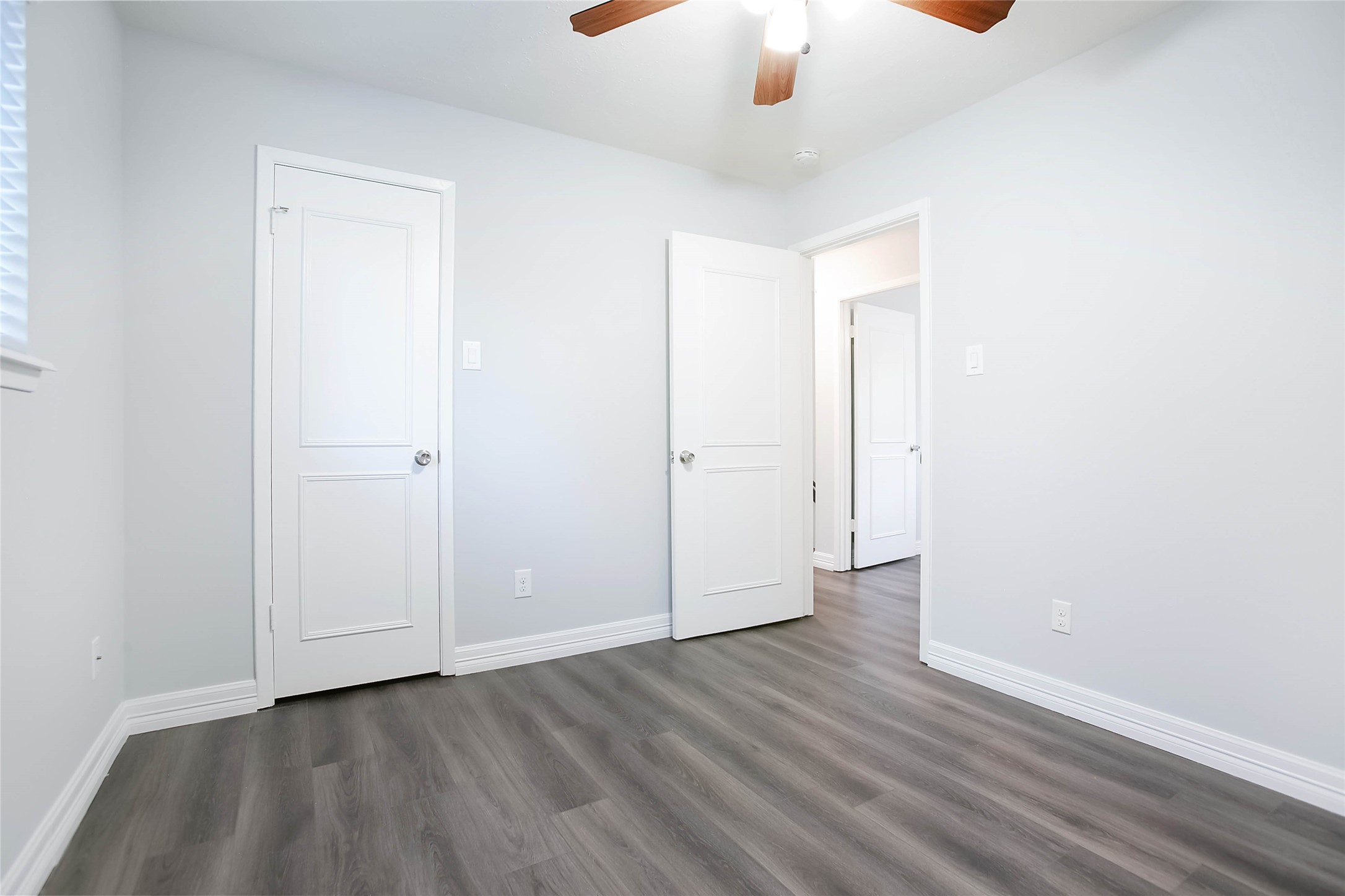 56 East White Willow Circle Spring, TX 77381 - Photo 30 of 45 an empty room with wooden floor chandelier fan