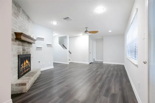 wooden floor in an empty room with a fireplace