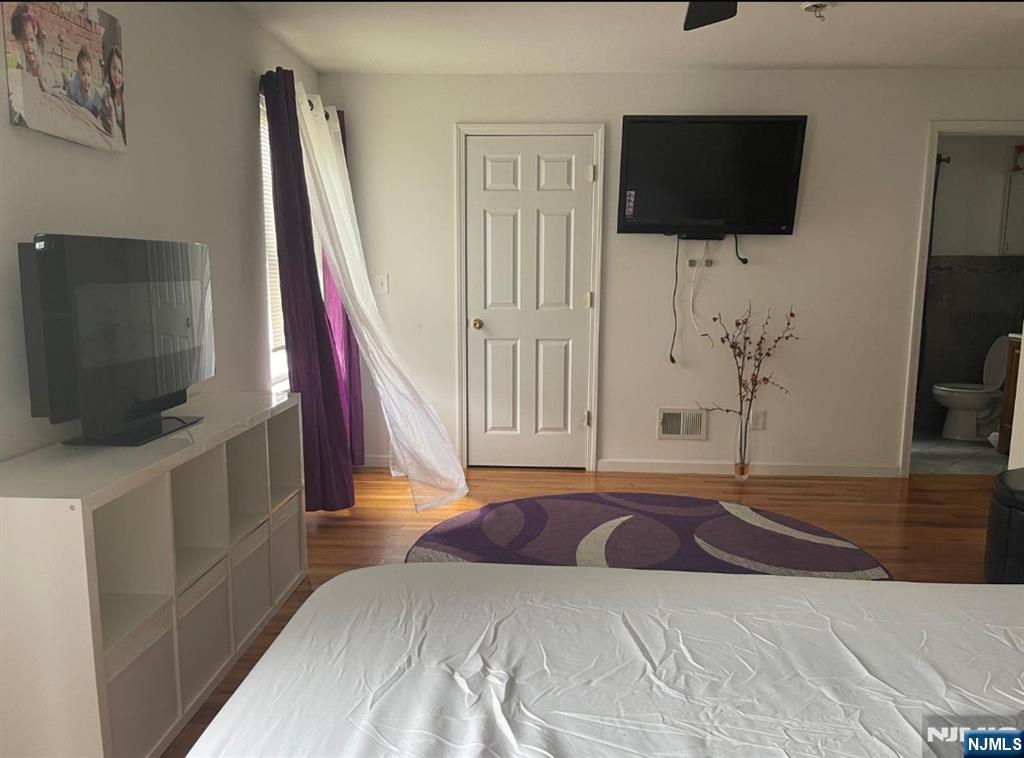 847 Bond Street, Unit 1 Elizabeth, NJ 07201 - Photo 1 of 10 a bedroom with a flat screen tv and a bed