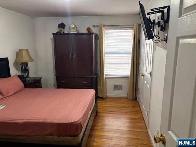 847 Bond Street, Unit 1 Elizabeth, NJ 07201 - Photo 4 of 10 a bedroom with a bed and wooden floor