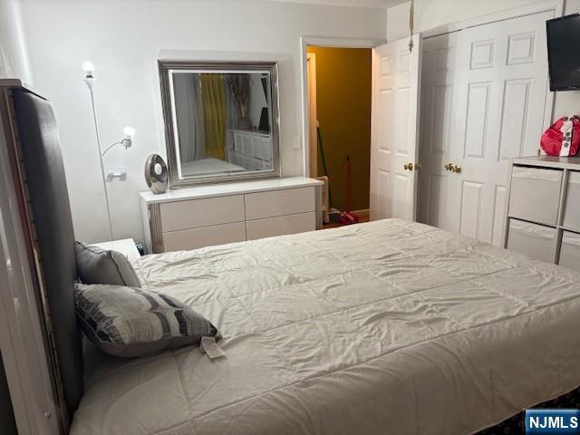 847 Bond Street, Unit 1 Elizabeth, NJ 07201 - Photo 6 of 10 a bedroom with a bed and a mirror