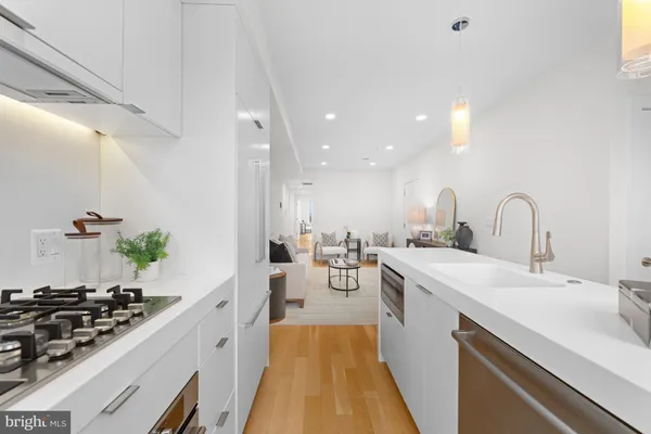 a kitchen with sink a stove and cabinets