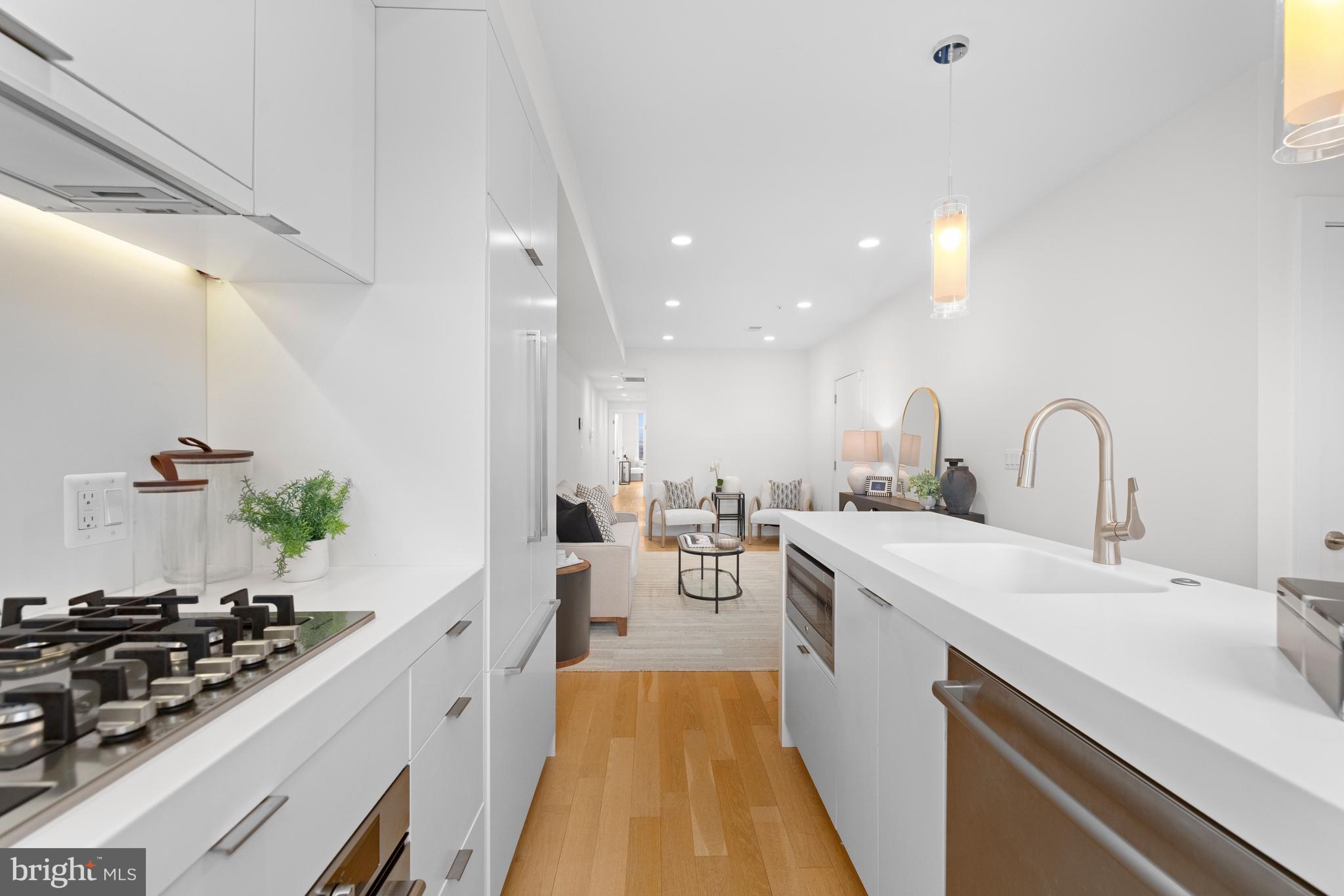 a kitchen with sink a stove and cabinets