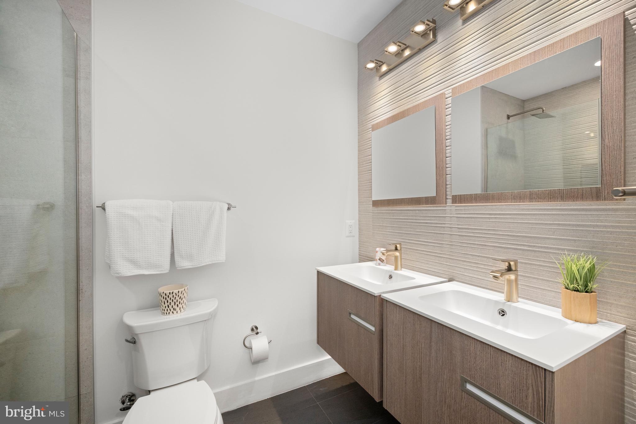 1515 K Street Southeast, Unit 3 Washington, DC 20003 - Photo 11 of 22 a bathroom with a sink a toilet a mirror and shower