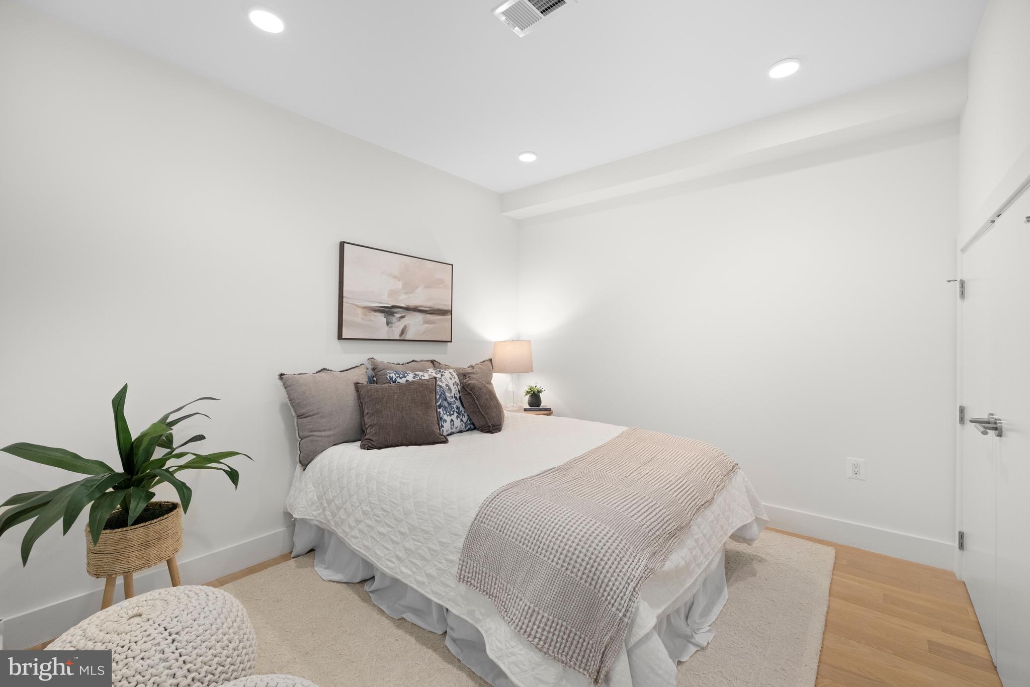 1515 K Street Southeast, Unit 3 Washington, DC 20003 - Photo 13 of 22 a bedroom with a large bed and a potted plant