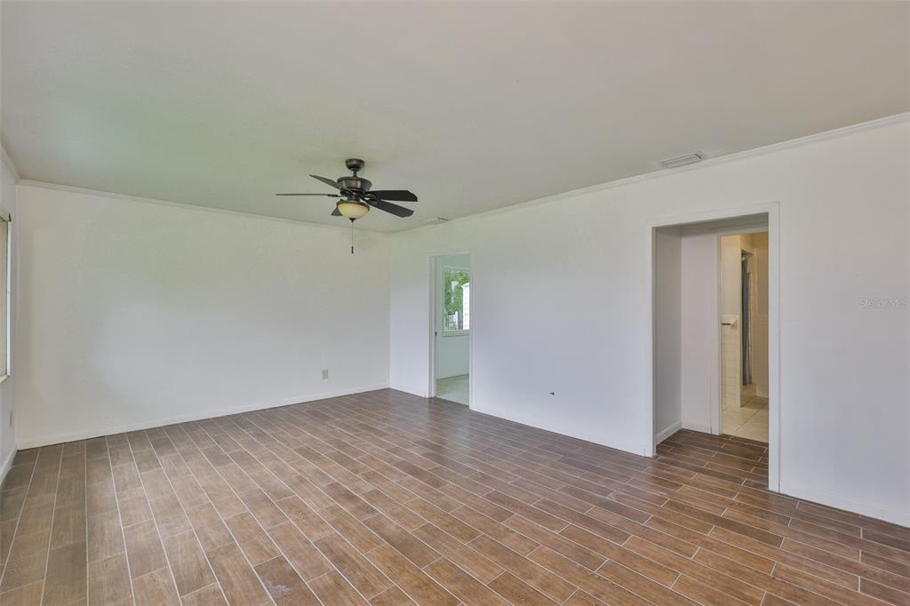 106 West North Branch Road Ruskin, FL 33570 - Photo 11 of 29 wooden floor in an empty room