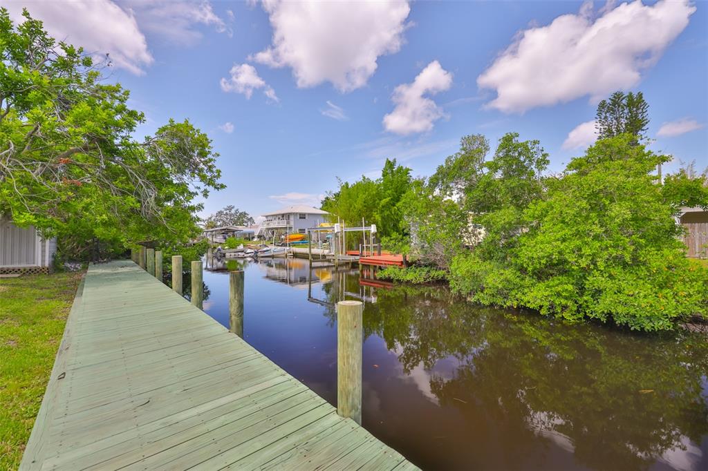 106 West North Branch Road Ruskin, FL 33570 - Photo 27 of 29 a view of a lake with a floor to ceiling window next to a yard