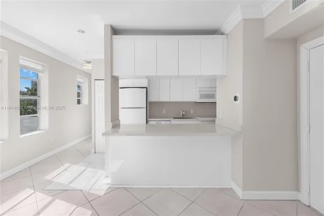 a view of kitchen with white cabinets